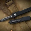 Microtech UTX-70 OTF Automatic Knife 2.4" Dagger Black Serrated 147-3T 2 Microtech UTX-70 OTF Automatic Knife 2.4" Dagger Black Serrated 147-3T -Southern Blades 147 3T 2 27703.1678166654
