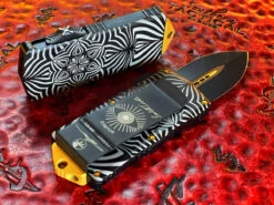 Microtech Exocet Double Edge, Two Toned Black W/ Gold Accents, Aircraft Allow W/ ‘Source’ Artwork 5 Microtech Exocet Double Edge, Two Toned Black W/ Gold Accents, Aircraft Allow W/ ‘Source’ Artwork -Southern Blades MT157 Source 3